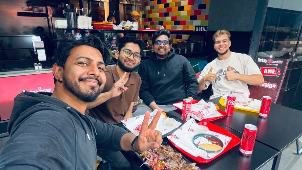 Four ProtocolHero team members enjoying lunch together at a kebab restaurant